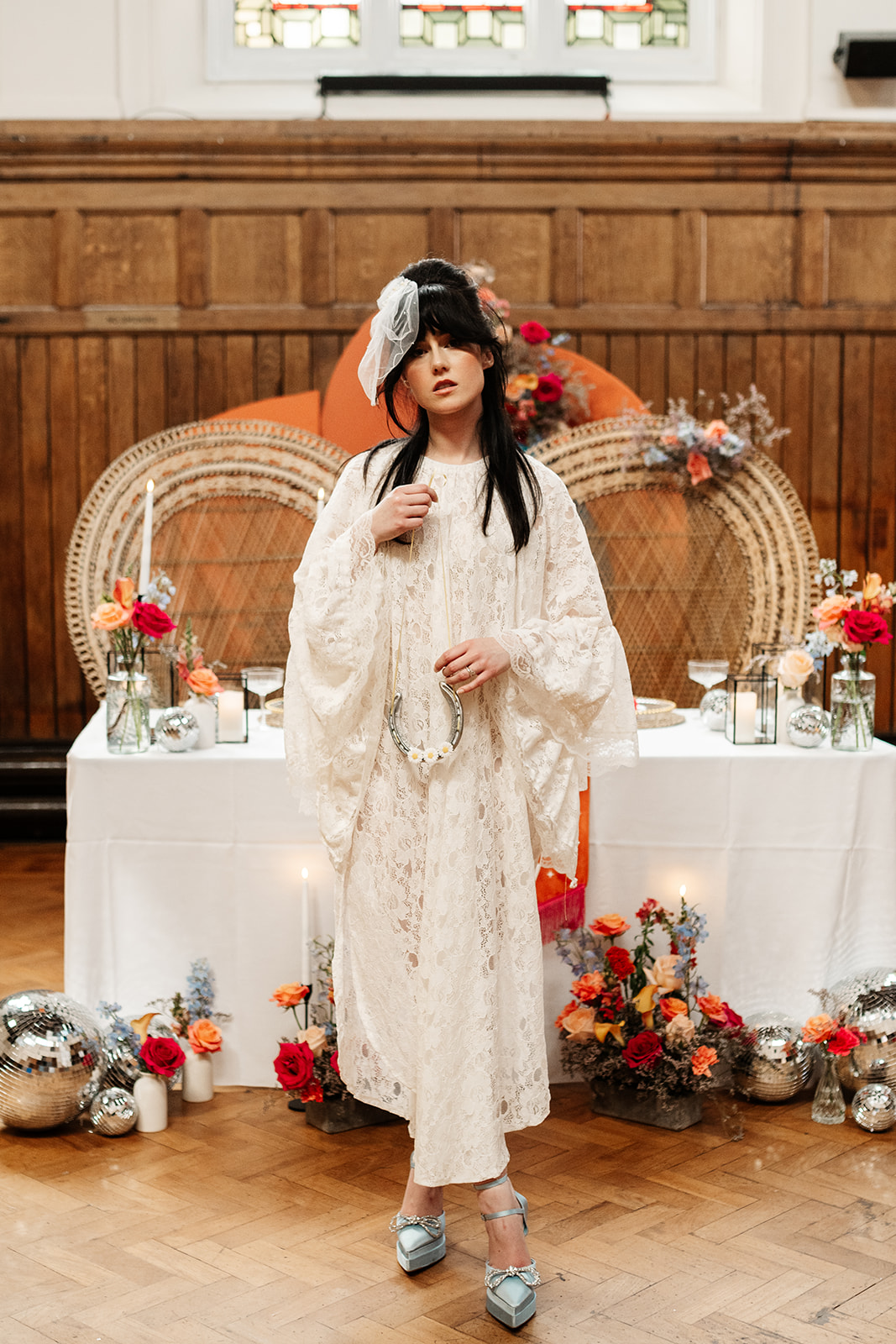 bride wearing kimono style wedding dress holding a lucky horse shoe as part of norther wedding