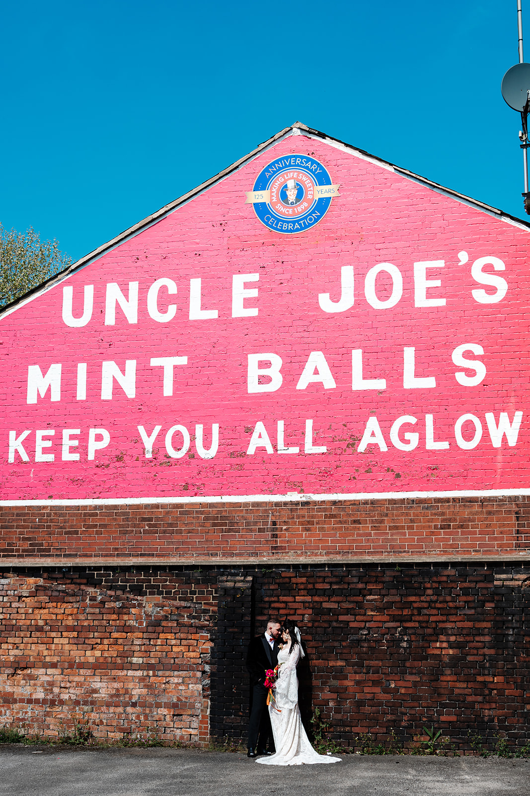 couple wedding portrait in front of uncle joes mint balls factory for wigan wedding
