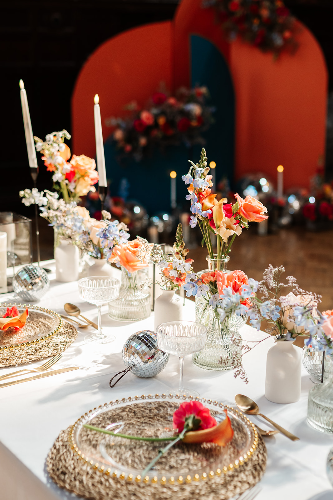 detail shot of pink, orange and blue wedding breakfast table flowers