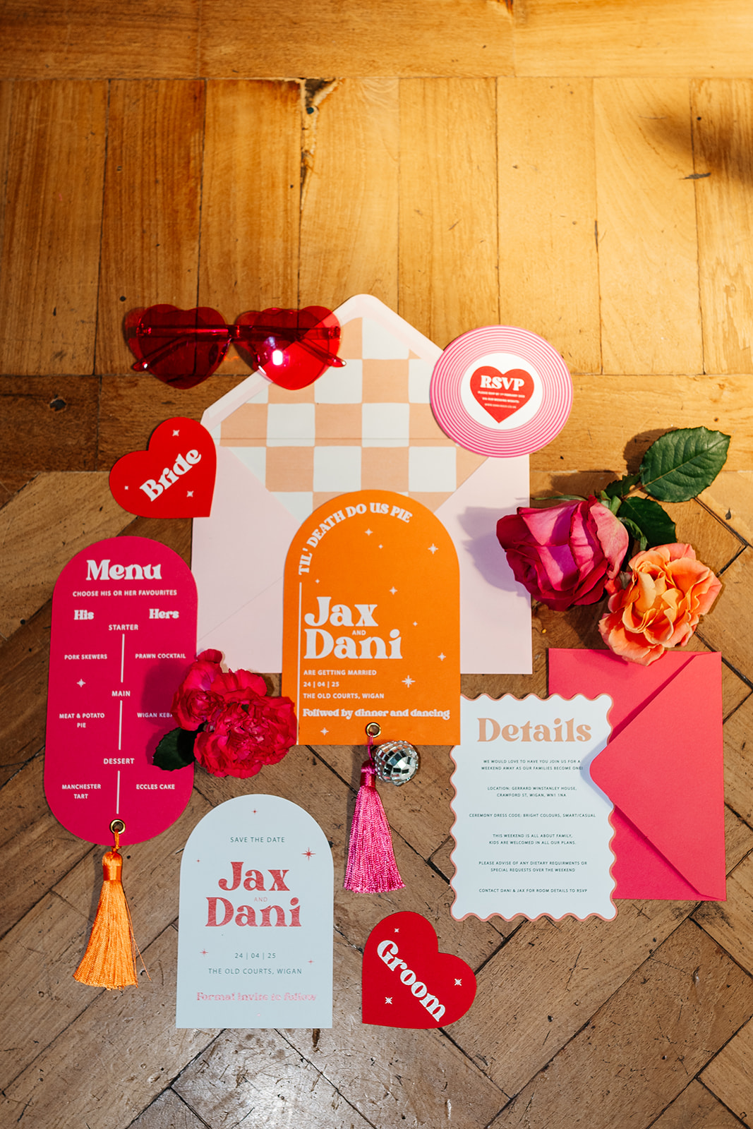 wedding flat lay of bright pink and orange northern inspired wedding stationery