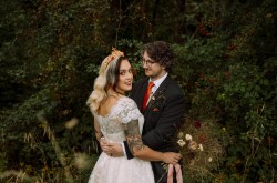 Bride and groom pose for a photo by a lake. Image taken by Heatherwood photography in manchester