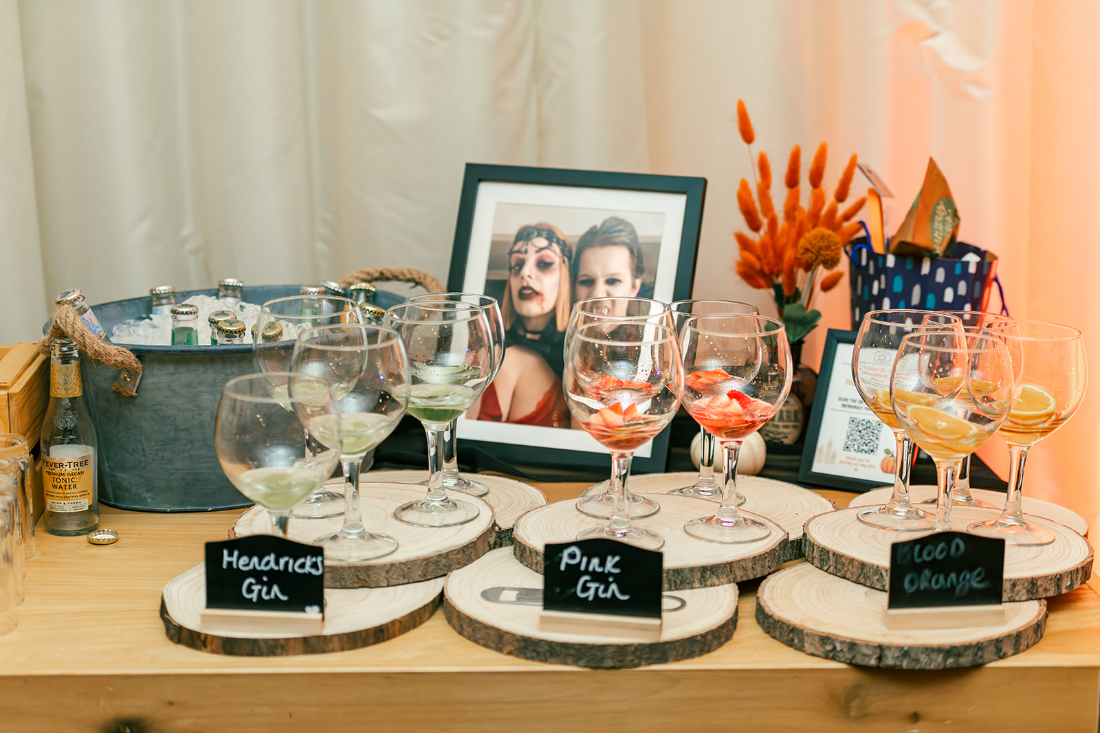 detail shot of the couple's Gin station with glasses of different flavoured gin and a bucket of different tonic waters.