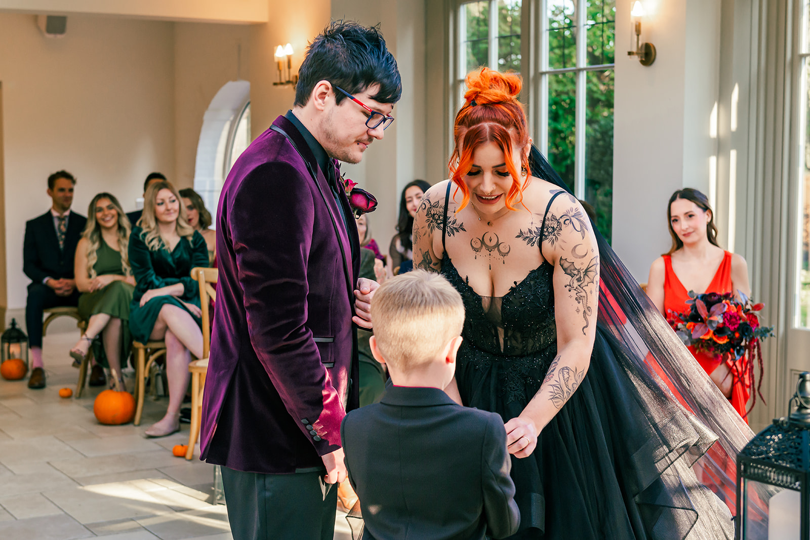 photo of the child best man giving the rings to his mum in during the Halloween inspired wedding ceremony