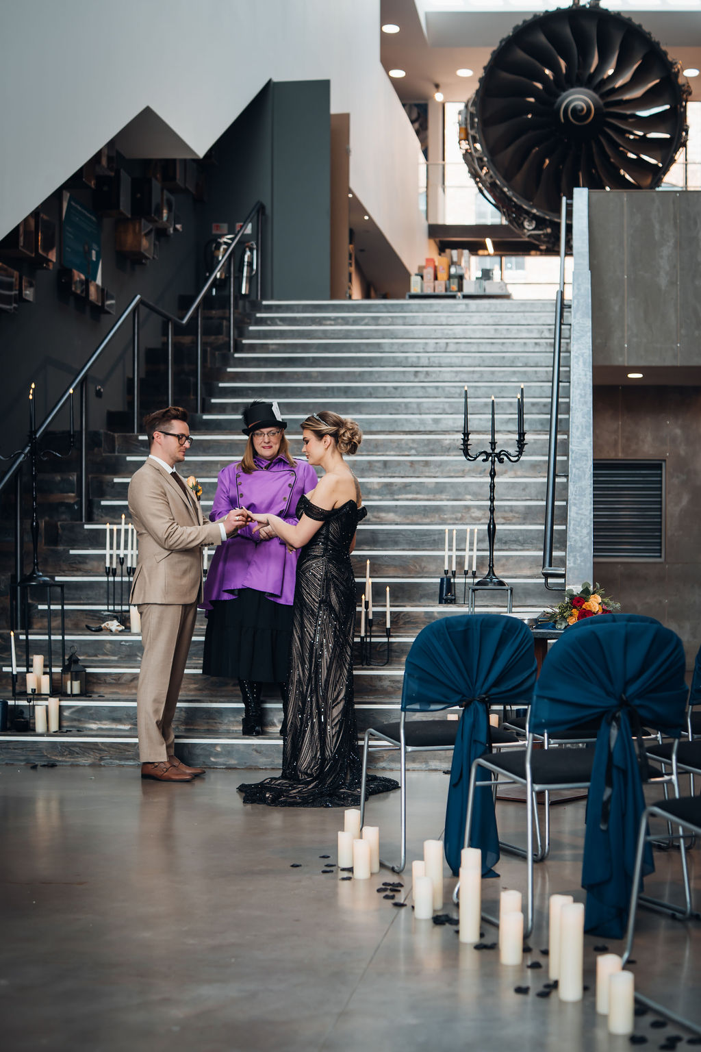 Derby Museum wedding ceremony space - an industrial staircase with candles, with seating set at an angle