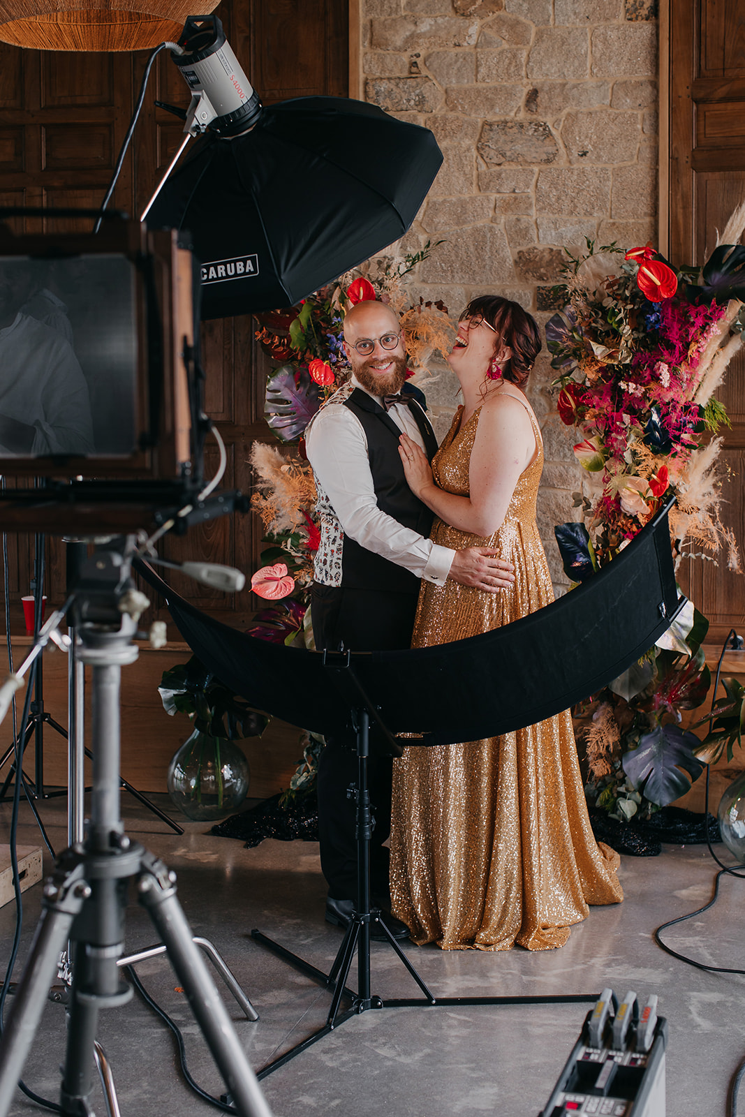 couple standing, posing to have a Collodion photograph taken. The old fashioned camera is in front of them