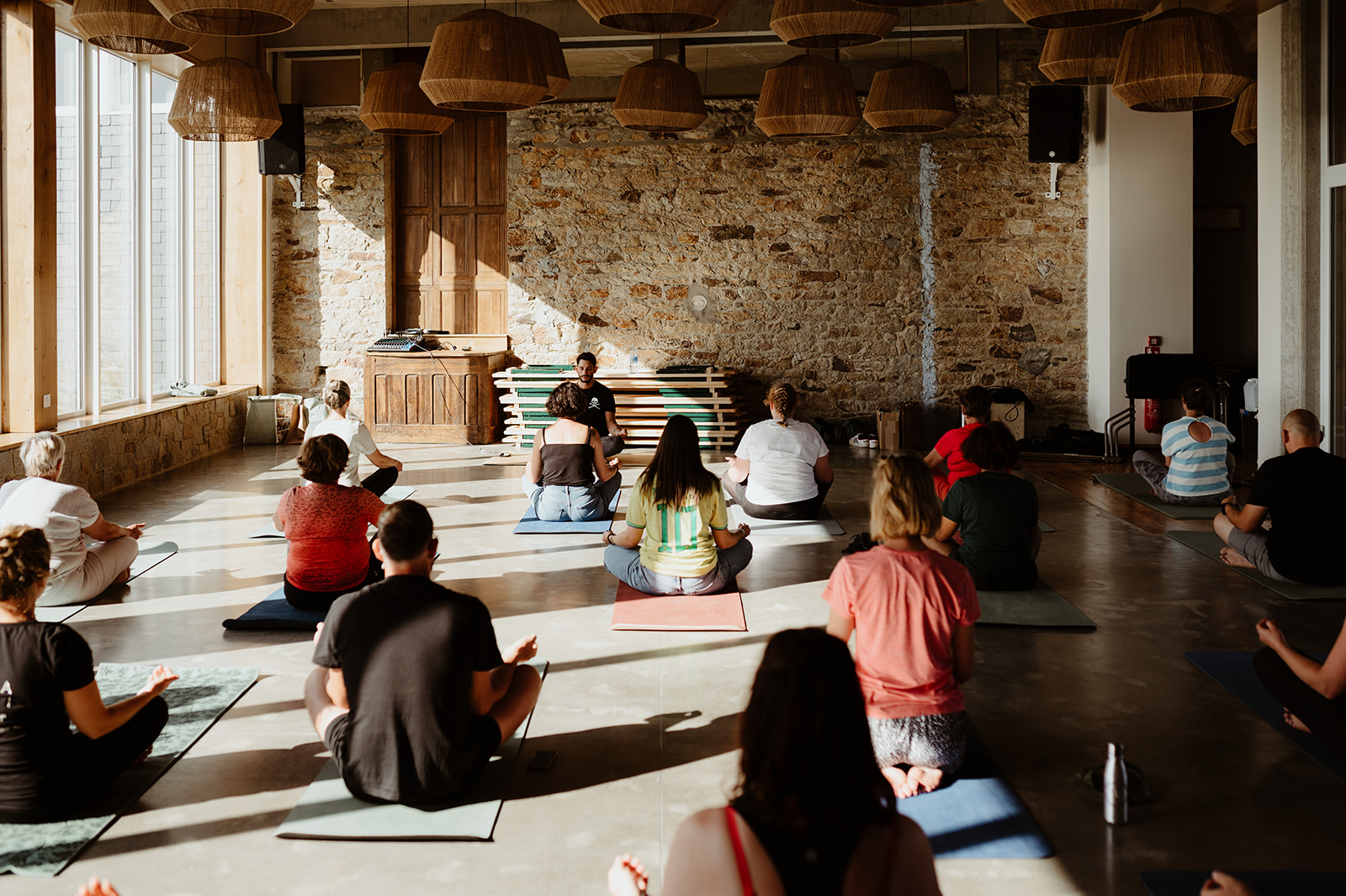 wedding guests taking part in a yoga session as part of a wedding weekend celebration
