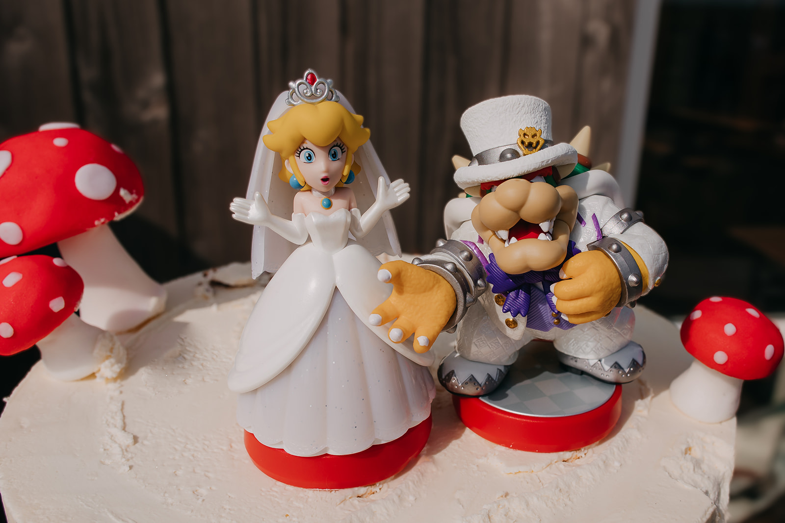 detail shot of princess peach and bowser from Mario Bros wedding cake toppers