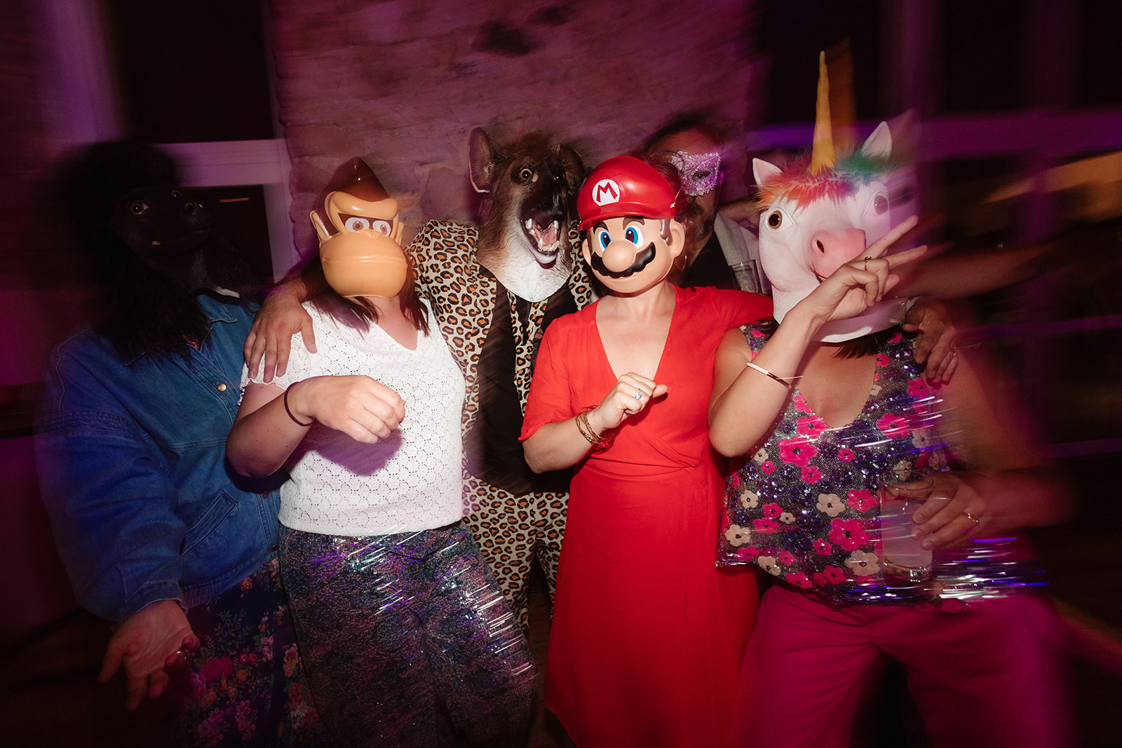 wedding guests wearing super mario bros masks dance at an unconventional wedding
