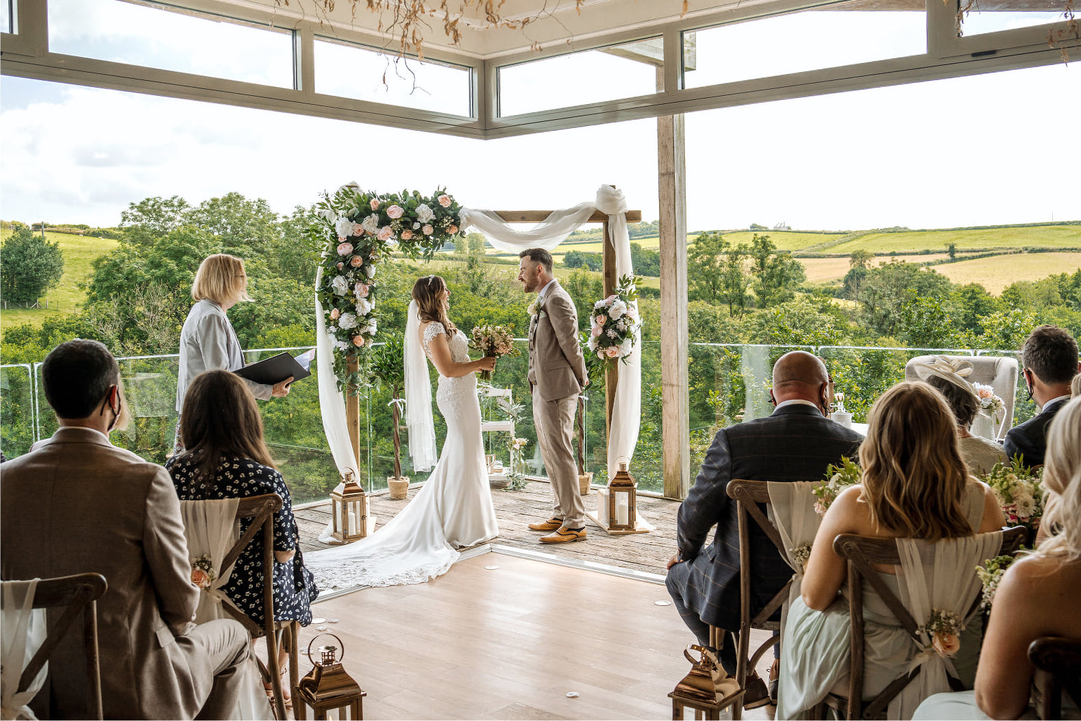 bride and groom get married on the terrace at tree top escape wedding venue in devon