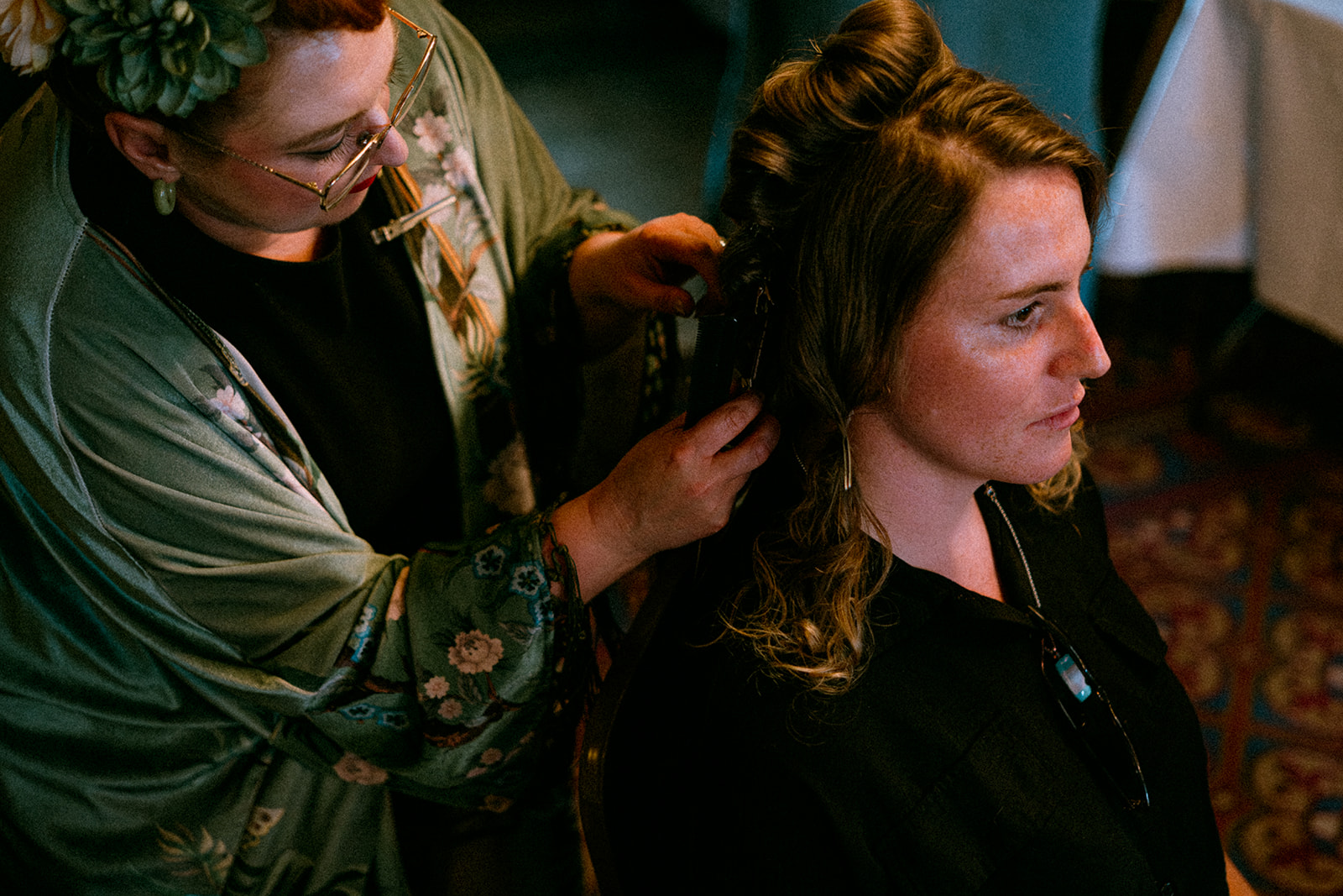 detail shot of Vintage Glamour with Anna creating soft curls in the brides hair