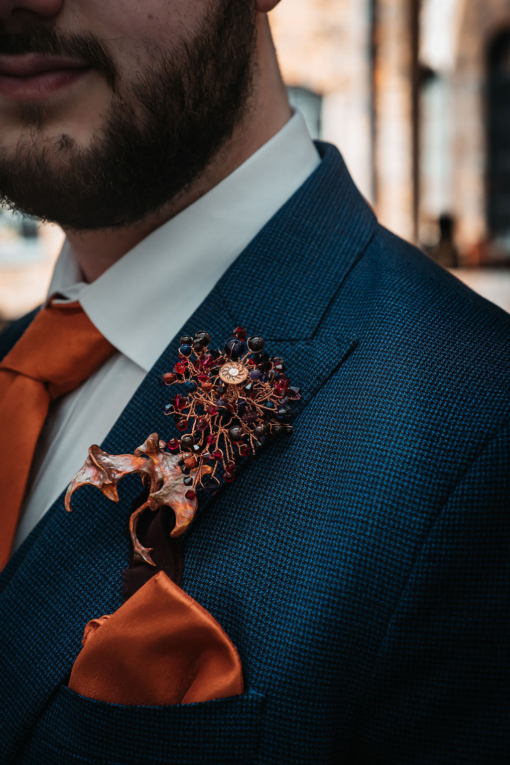 detail shot of a handmade alternative button hole with copper wire, beads and copper dragon