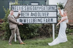 newlyweds post with a personalised holywood sign at the wellbeing farm wedding venue in lancashire