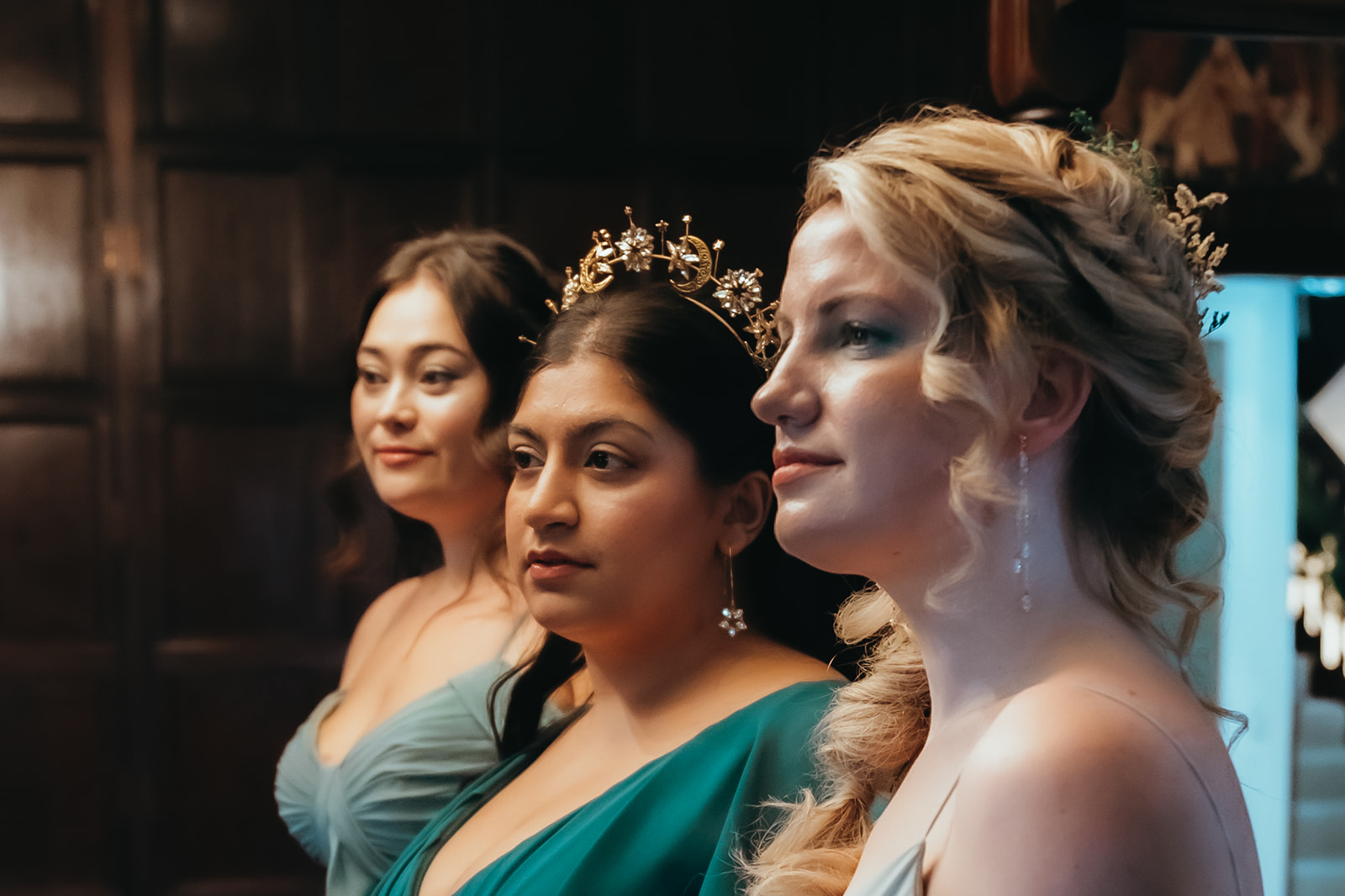 close up of three women's faces who have fresh bridal makeup ready for winter wedding