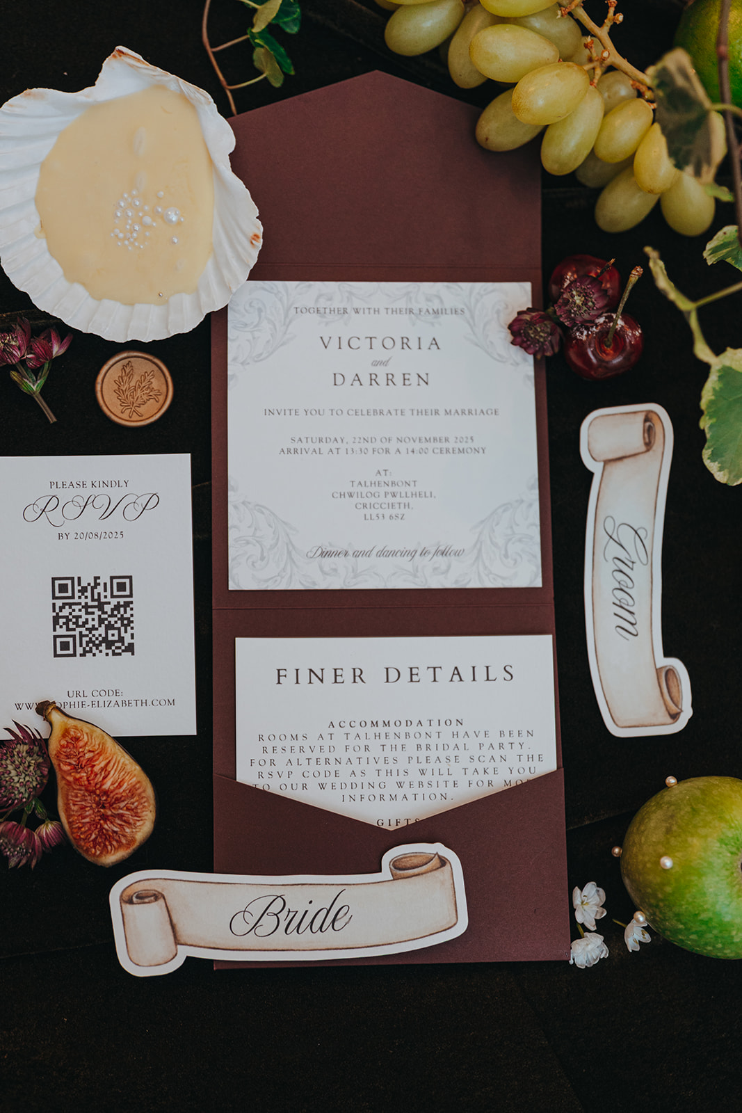 detail flat lay shot of renaissance inspired wedding stationery with scroll place settings
