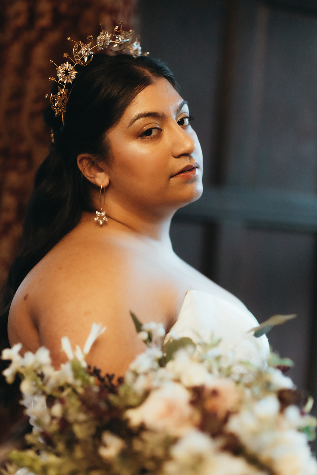 detail bridal portrait showing the brides makeup, star crown and earrings.