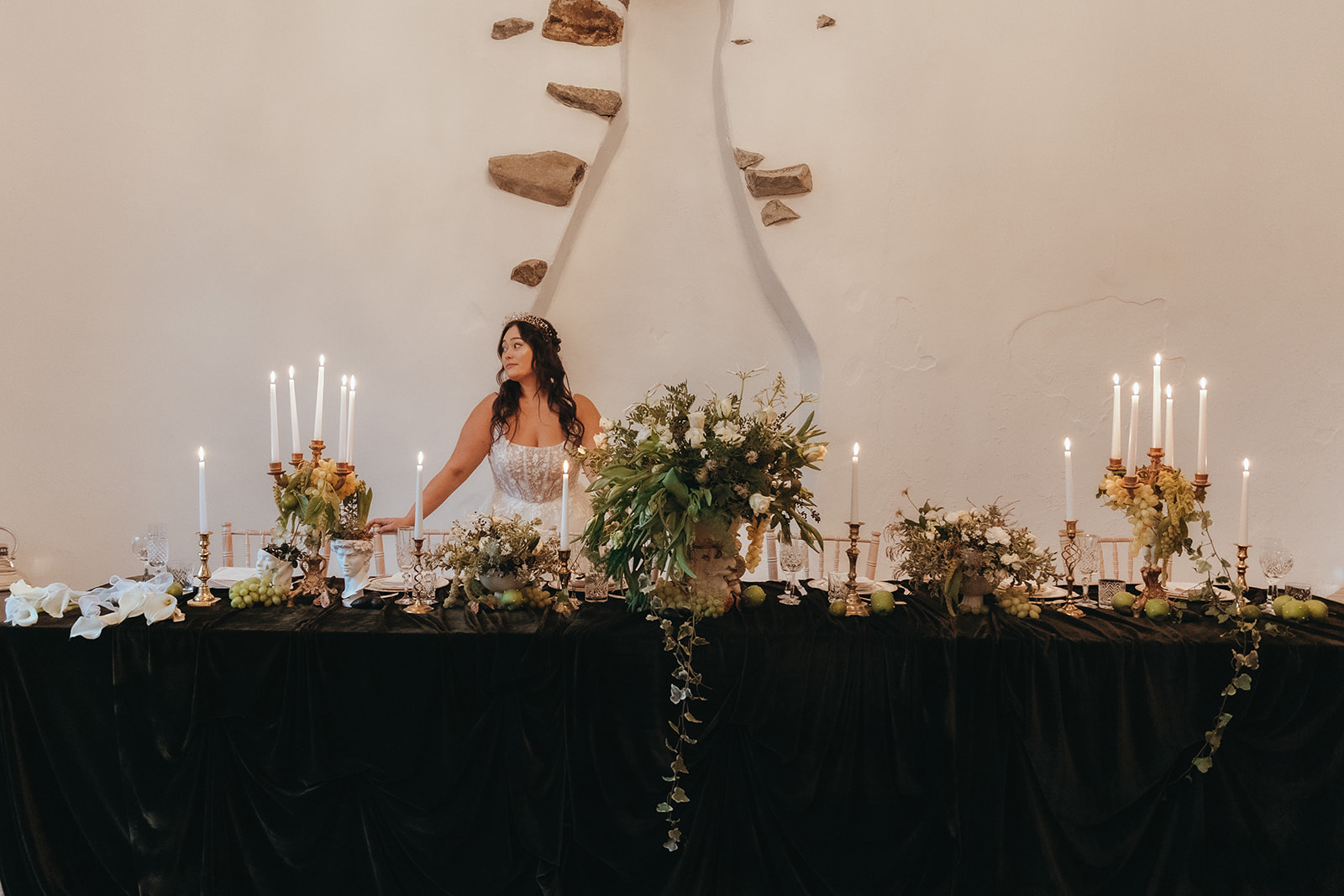 deep green wedding breakfast table with stone urns and sculptures holding flowers and grapes for Renaissance style wedding