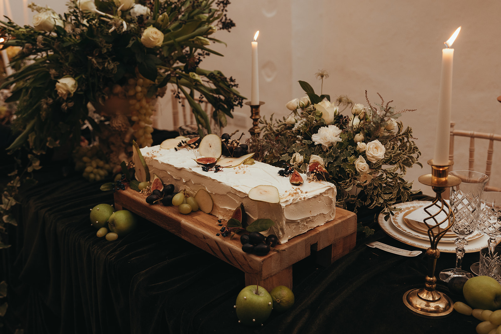 detail shot of a long oblong wedding cake covered in slices of fruit for Renaissance wedding
