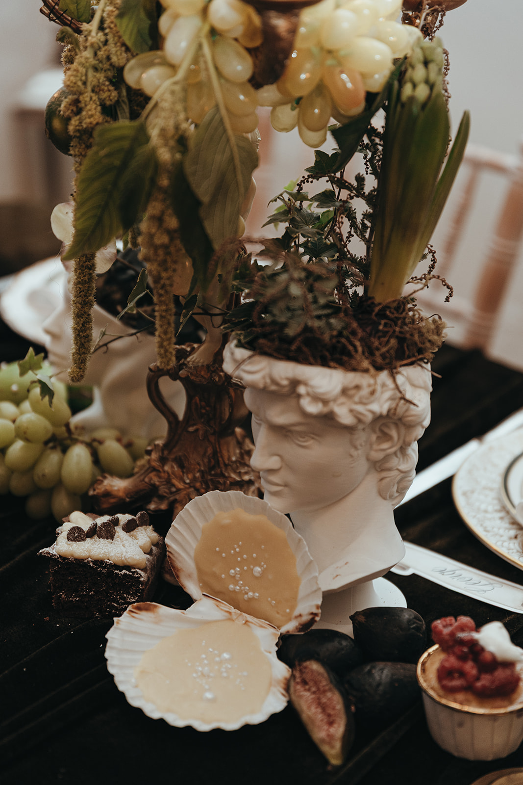 detail shot of a desert in a scollop shell on the Renaissance inspired wedding breakfast table.