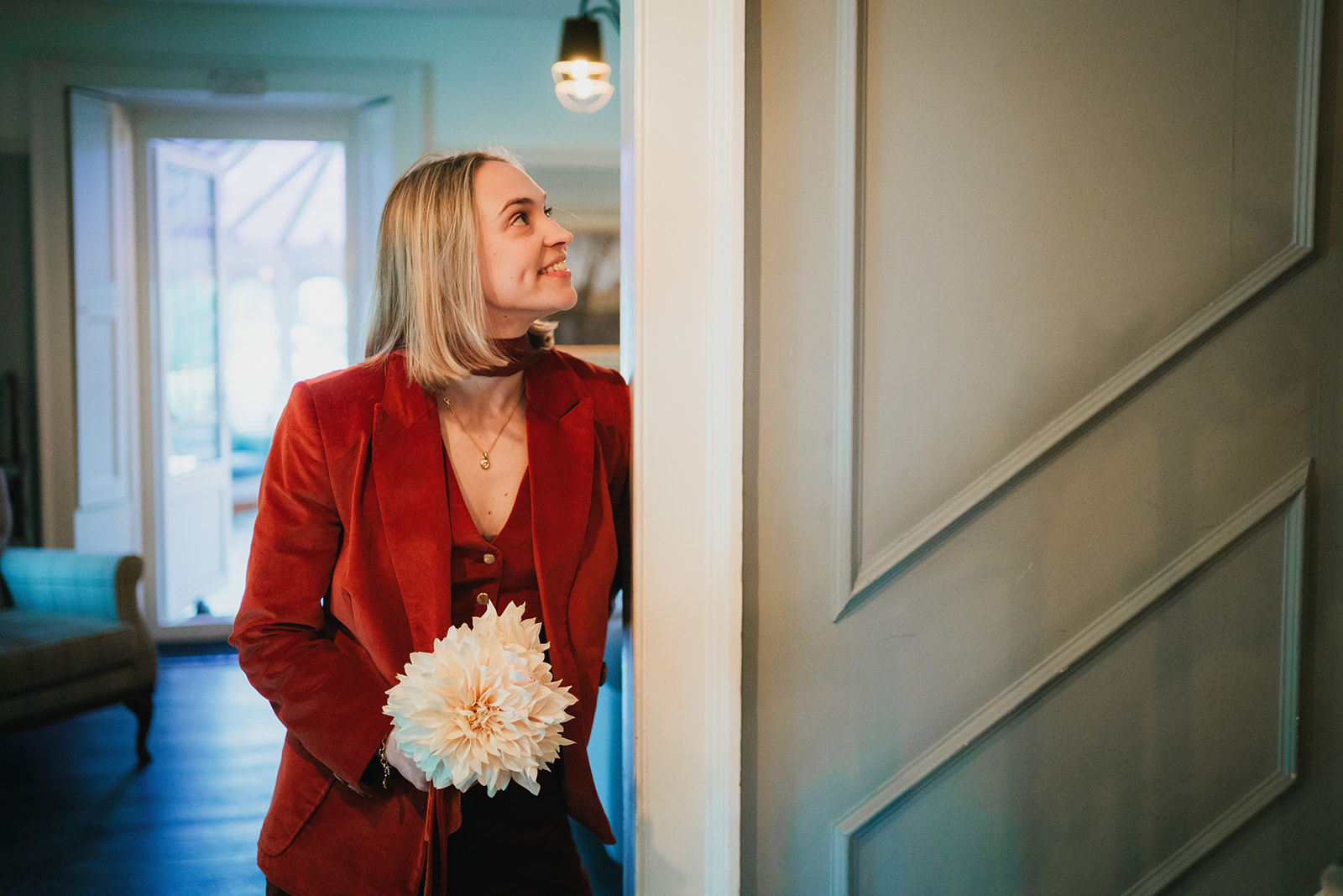 bride waits at the bottom of the stairs for her first look with her bride