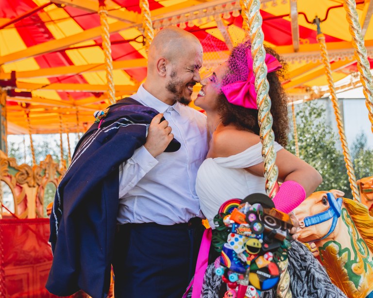 alternative couple get married at the fun fair. Image taken for the quirky wedding fayre