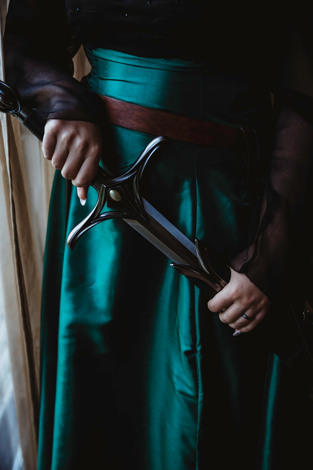 detail shot of the bride holding the hilt of her sword as part of a Viking wedding
