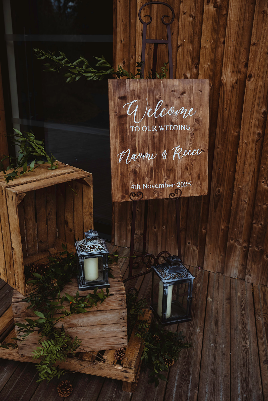 wooden crates, lanterns and welcome sign as part of outdoor wedding