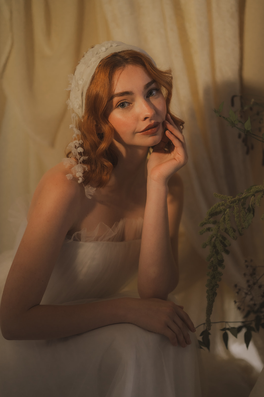 Bride softly lit wearing a Molly Francis Studio boho headpiece