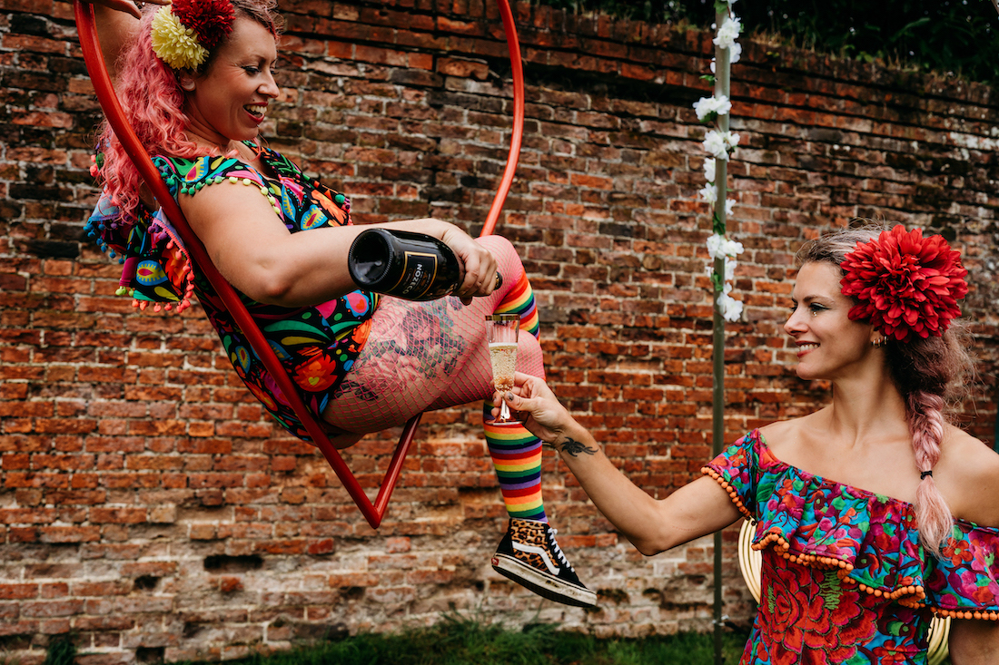 circus performers pouring champagne at a festival wedding