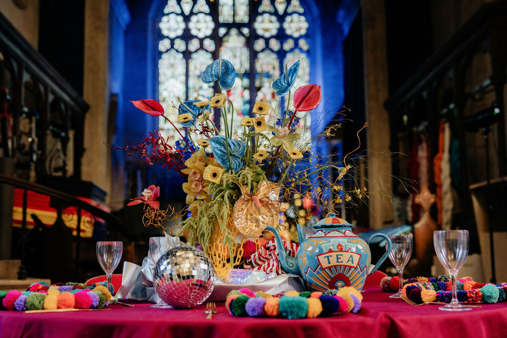 detail shot of alternative circus wedding breakfast table with fairground inspired painted teapot