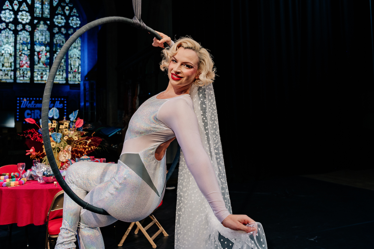 bride wearing stretch jumpsuit in an areal ring for circus wedding