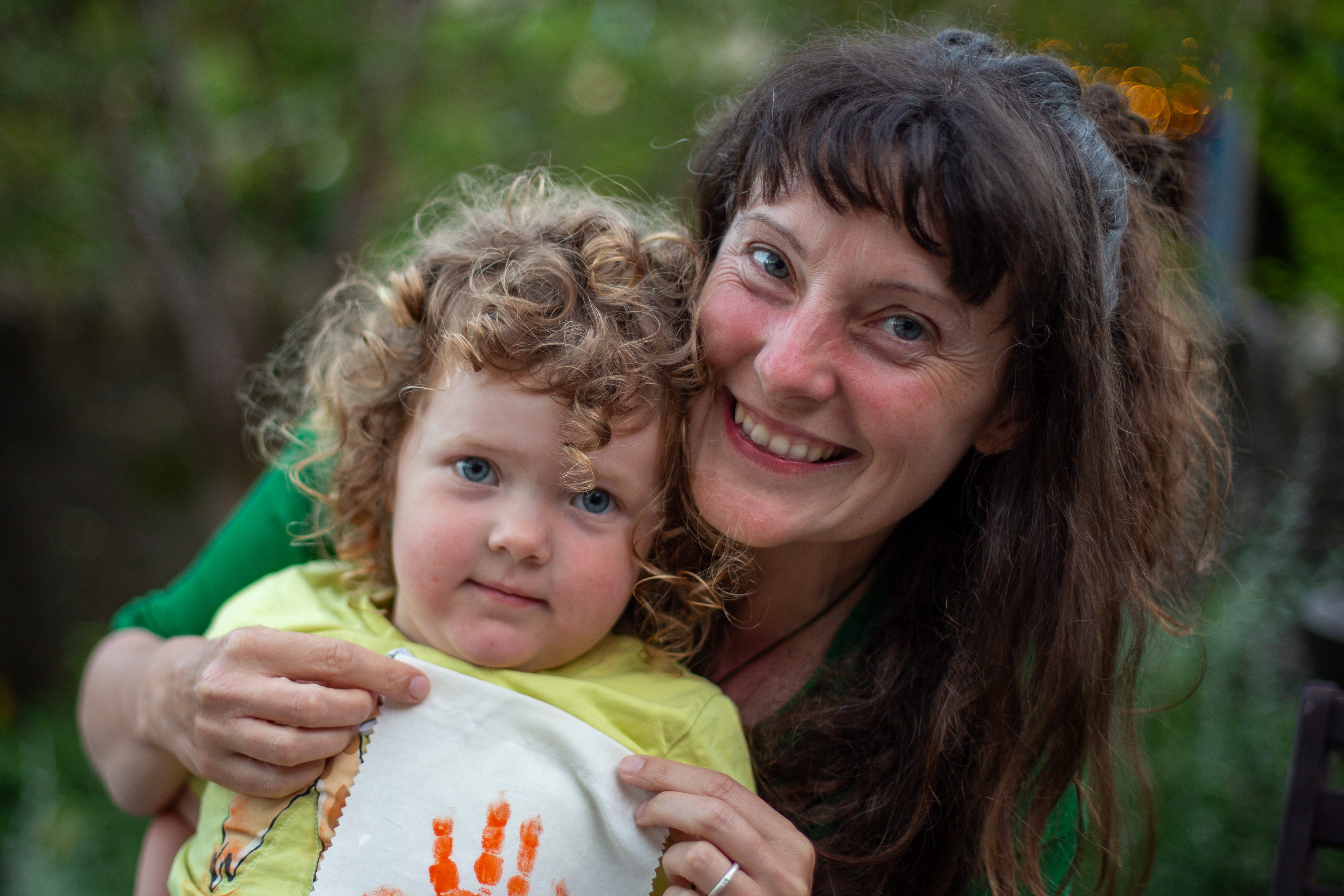 A woman and child smiling at the camera