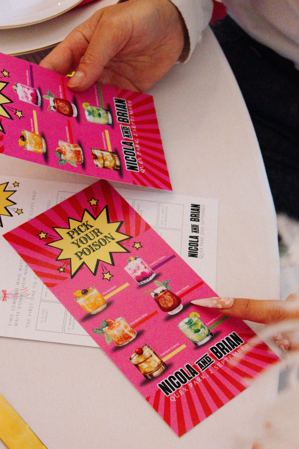 detail shot of 'pick your poison' cocktail cards with carnival theme