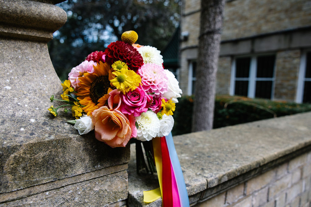 detail shot of bright wedding bouquet with colourful ribbons