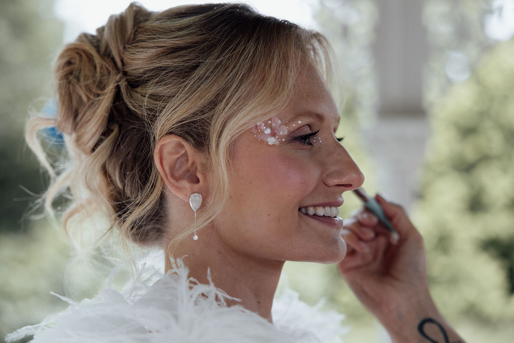 bride with pink butterfly glitter and pearls by the eyes