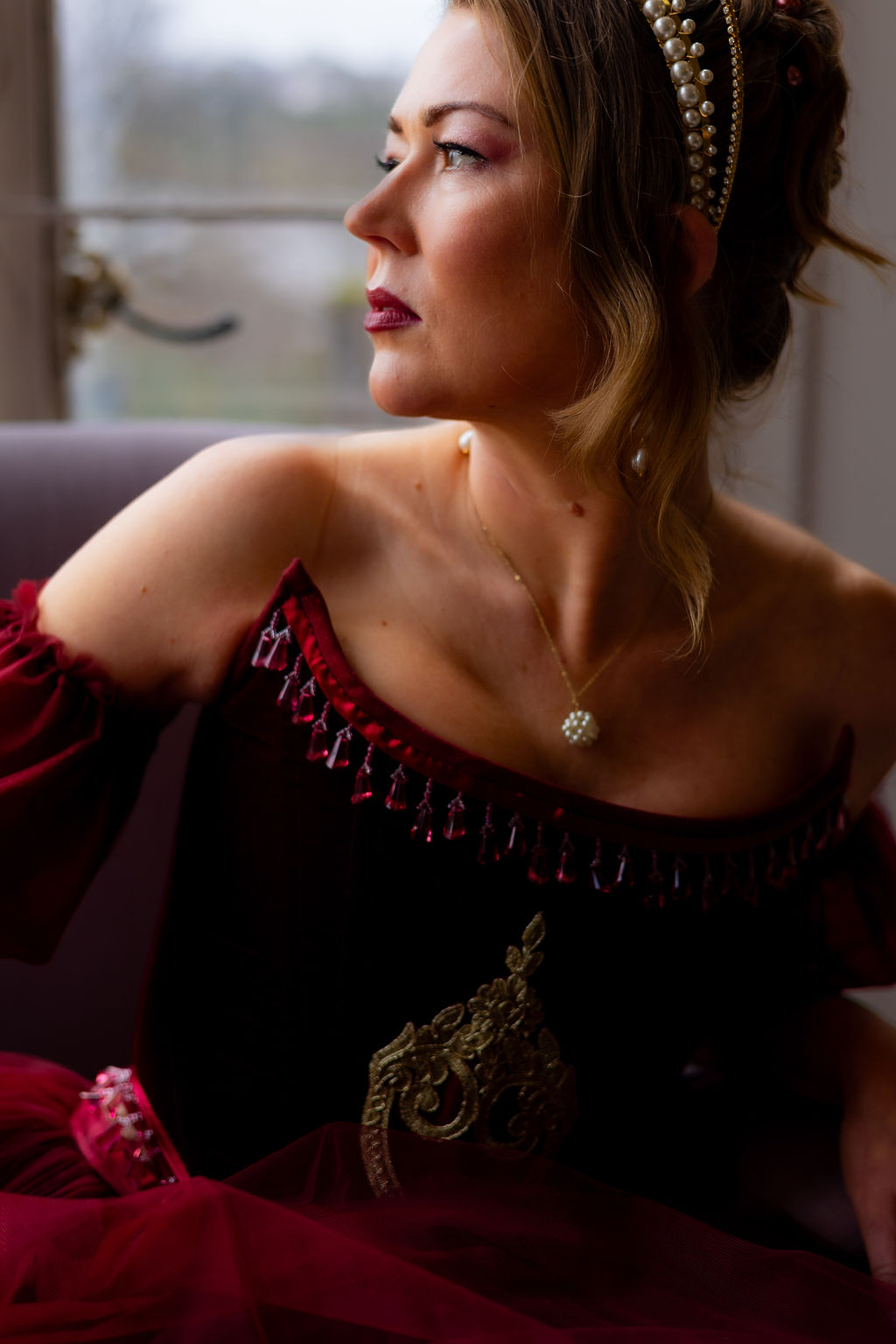 close up shot of bride showing the beadwork along the top of the corset and her pearl necklace