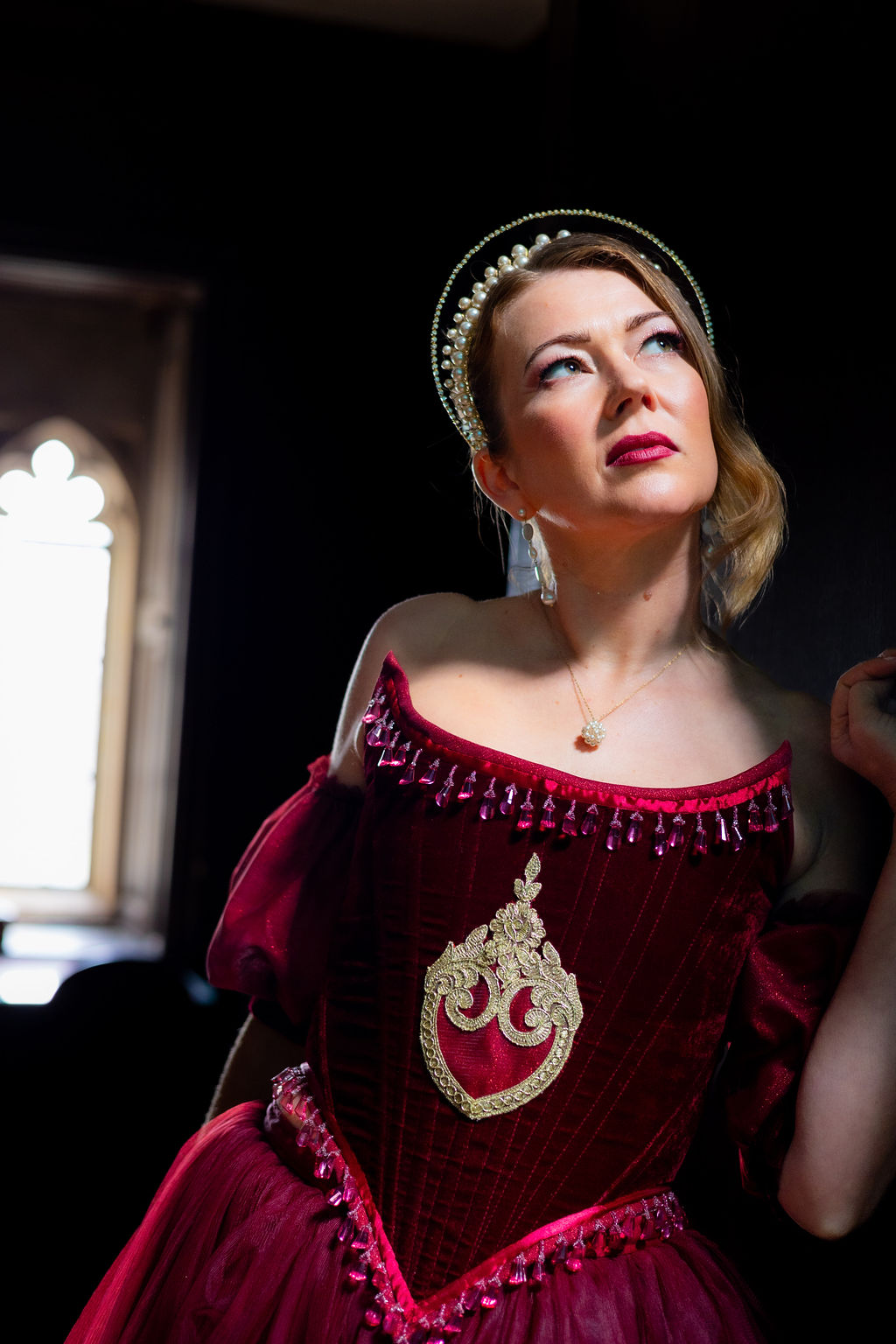 atmospheric bridal portrait of bride standing in a doorway of her historical wedding venue