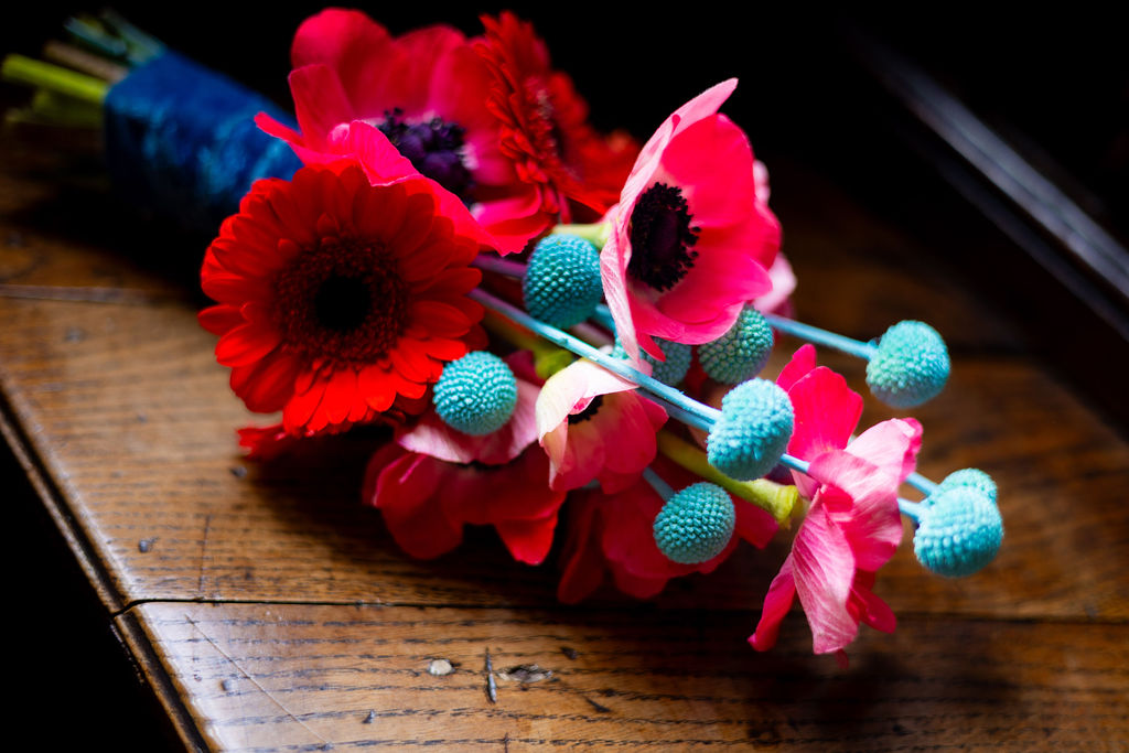 detail shot of red and turquoise alternative wedding bouquet