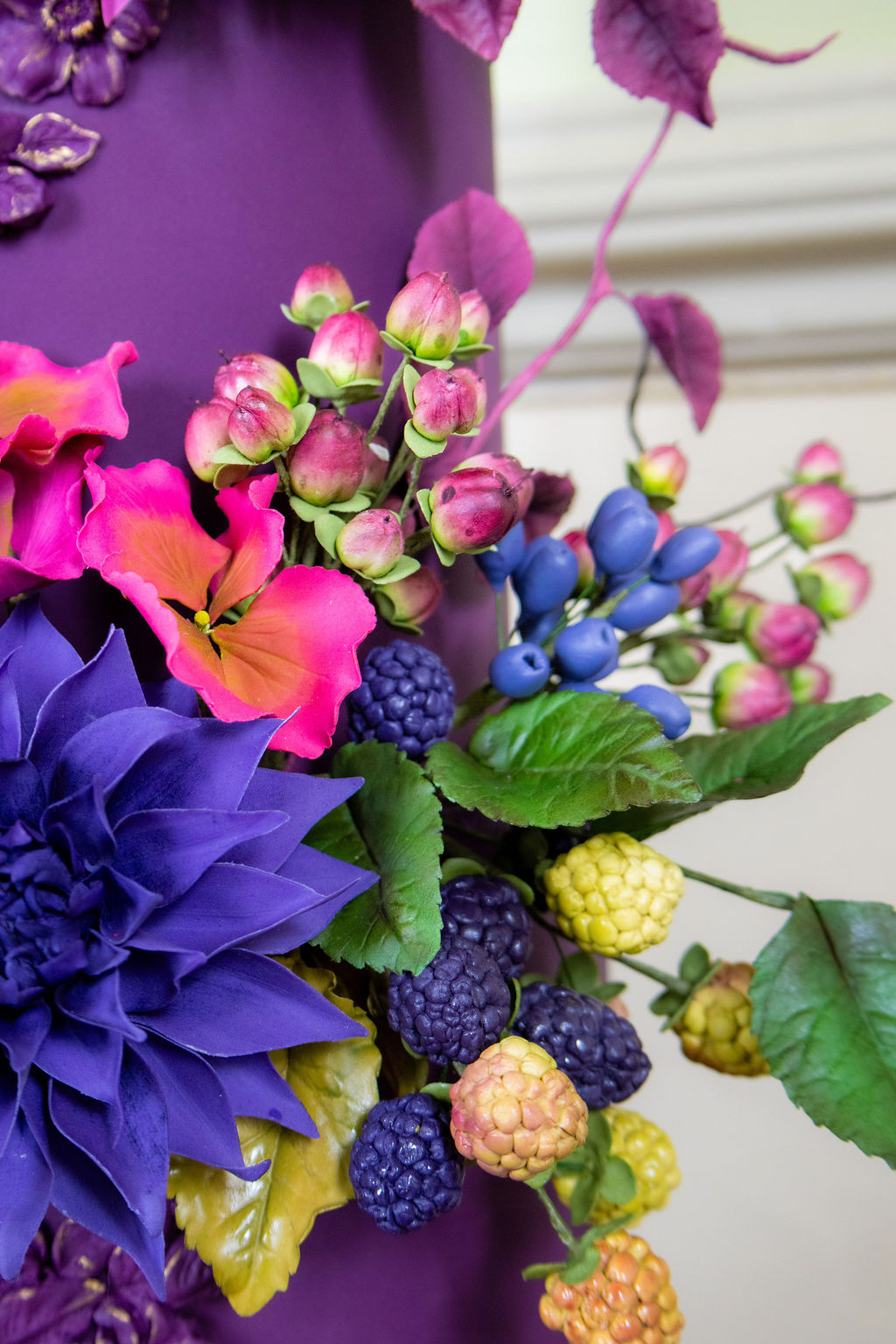 detail shot of sugar flowers and fruit on alternative wedding cake
