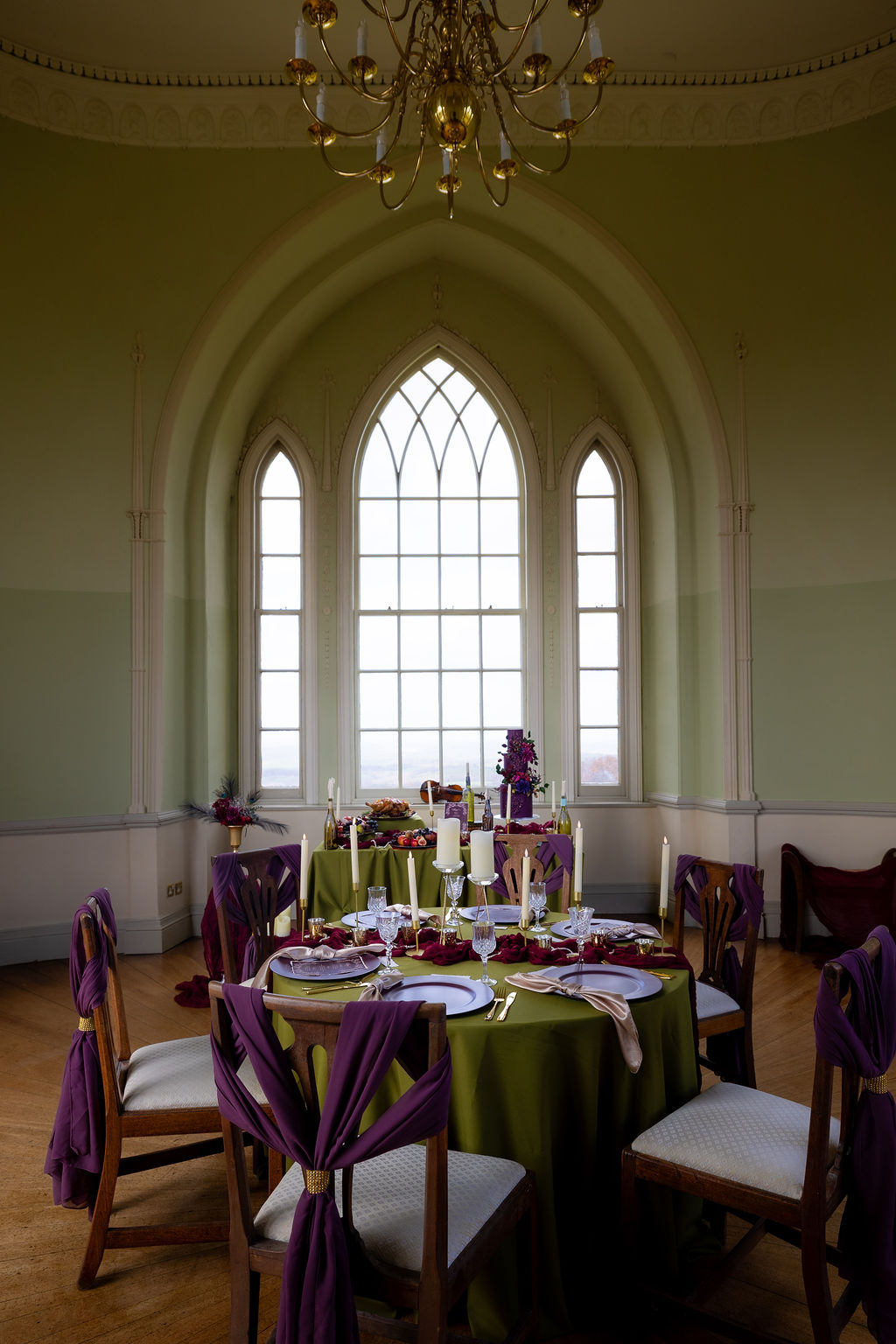Historical Devon wedding venue set with green and purple wedding breakfast tables