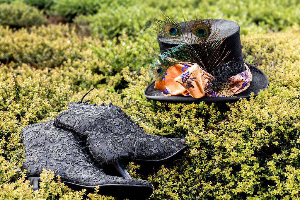 detail shot of victorian inspired boots with top hat with birdcage veil