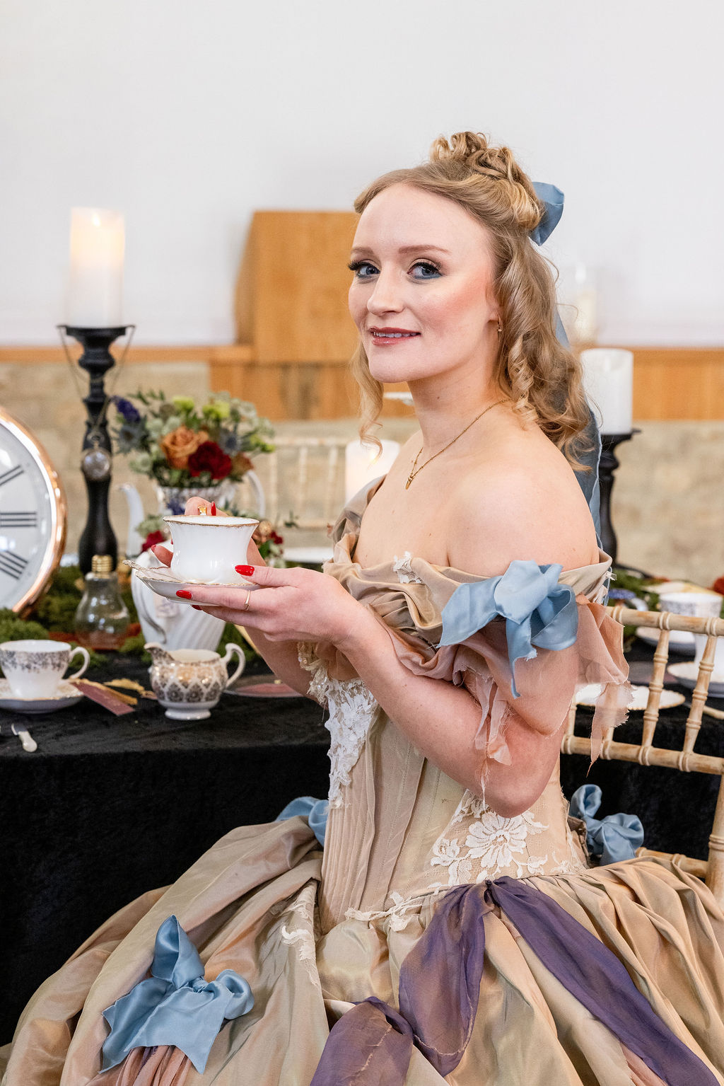 model bride wearing Alice in Wonderland style dress drinking tea
