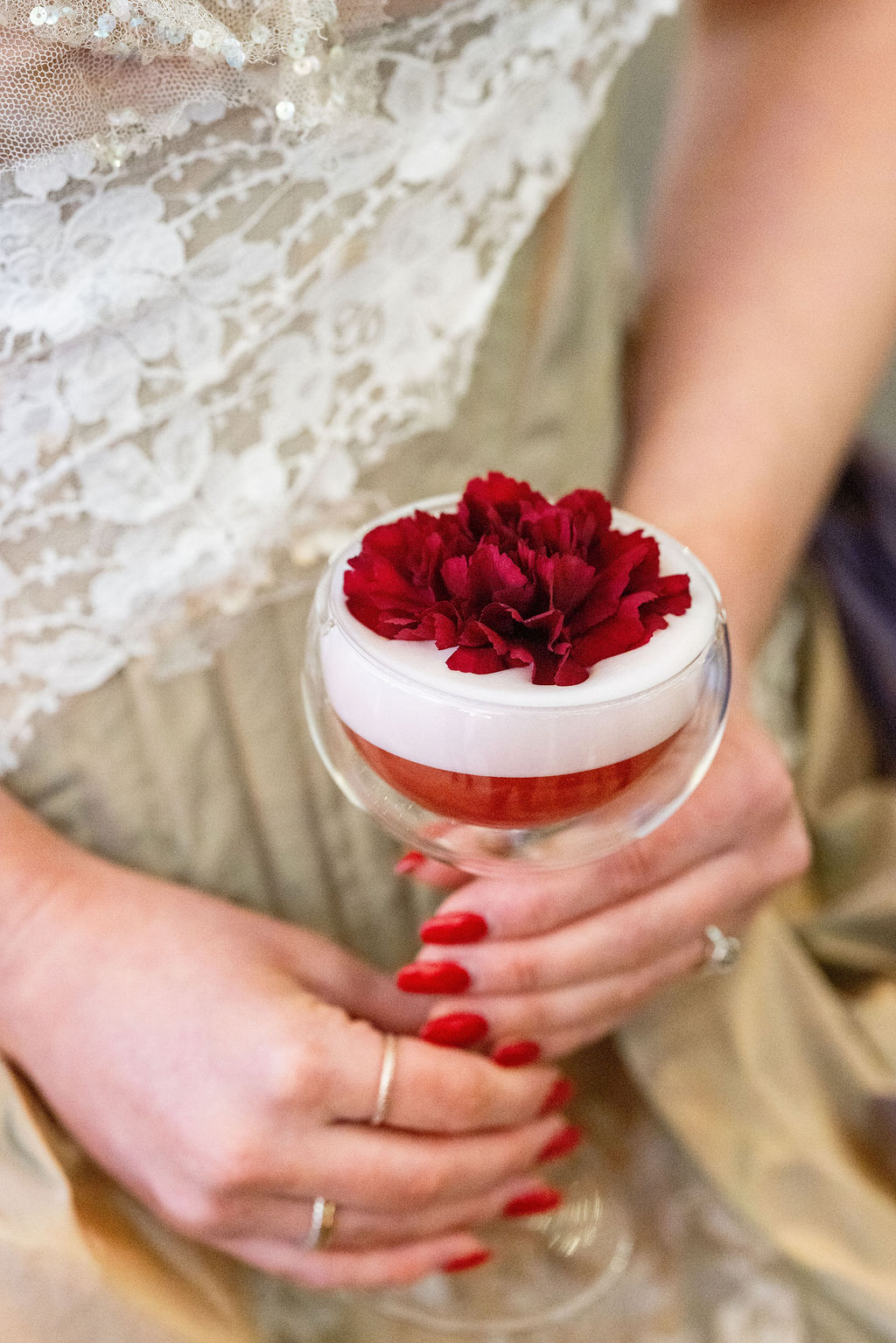 detail shot of a red cocktail in a bubble glass for Alice in Wonderland themed wedding