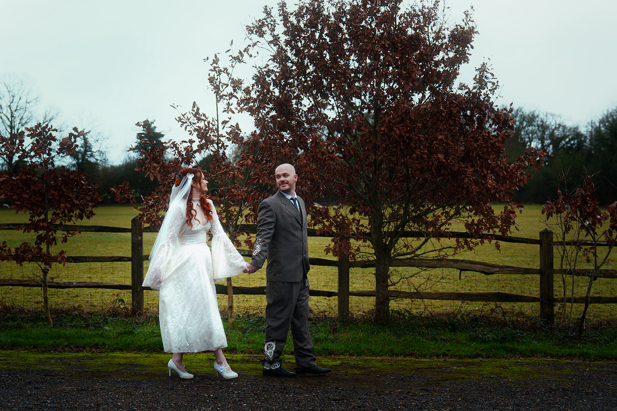 Couple walk outside their Welsh wedding venue