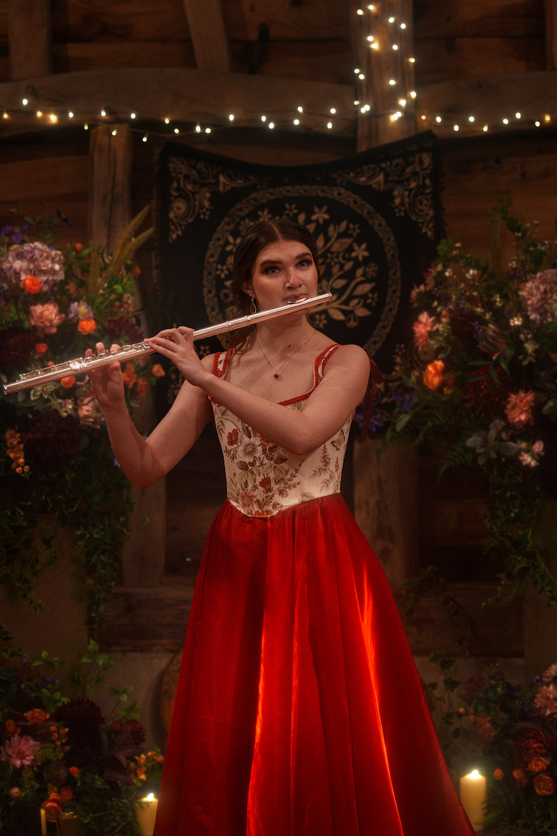 portrait of wedding flute player in corseted red dress