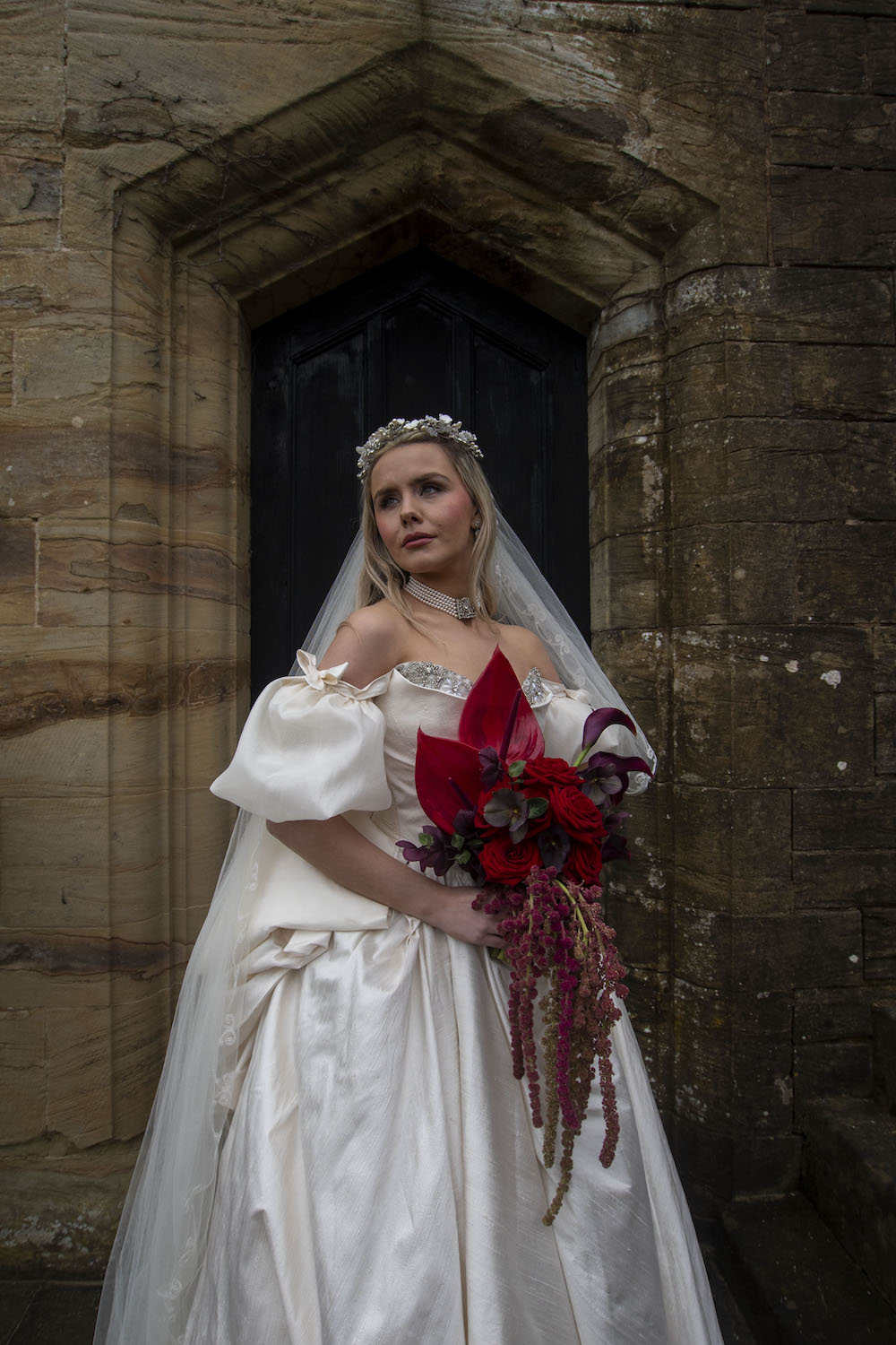 bride wearing statement ballgown holding alternative wedding bouquet for Wuthering Heights wedding