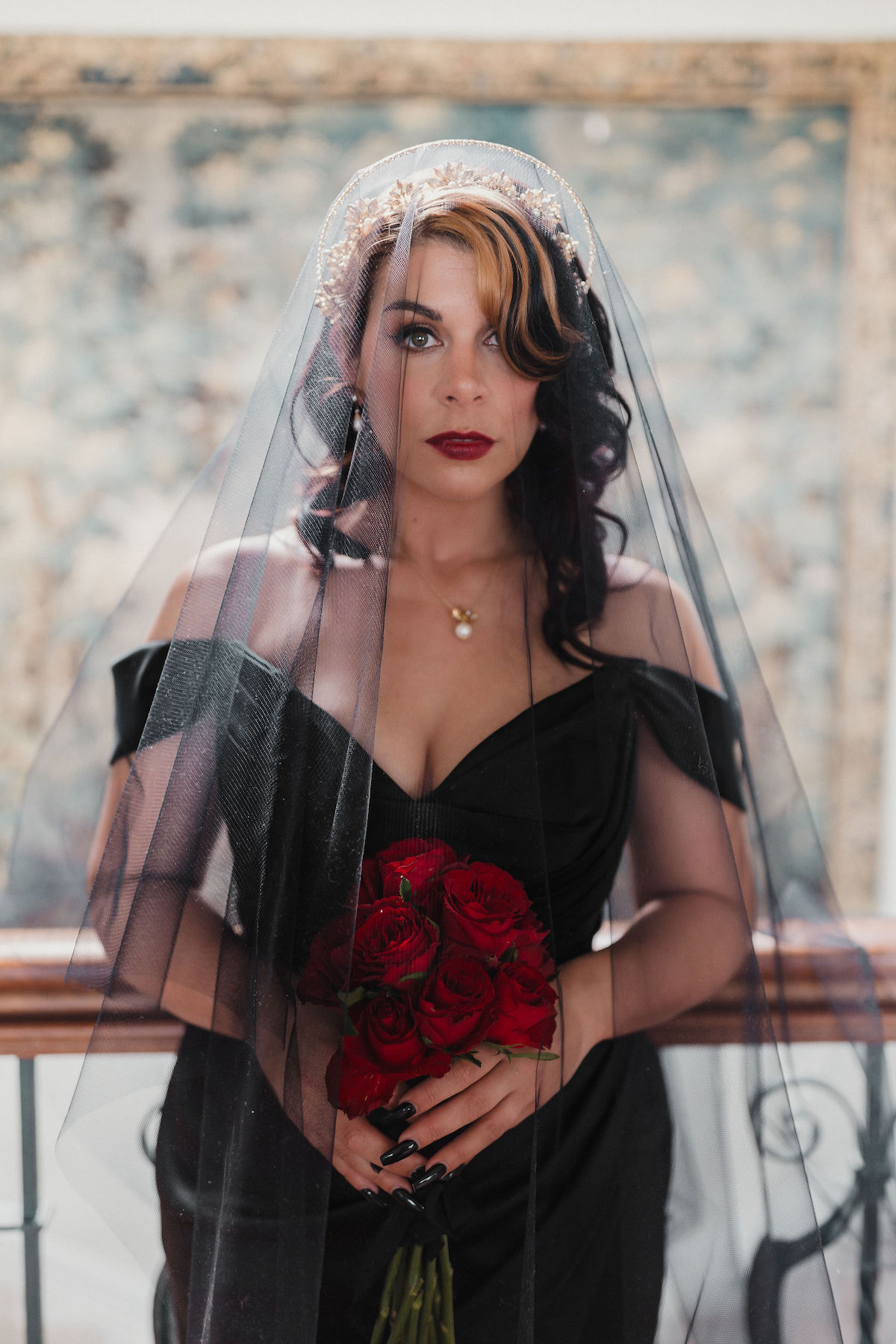 bridal portrait showing vintage style hair and makeup, statement rhinestone hair accessories and black wedding dress