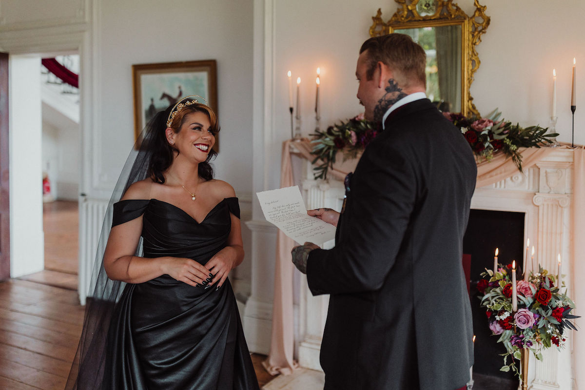 groom reading his love letter to his wife during the wedding ceremony