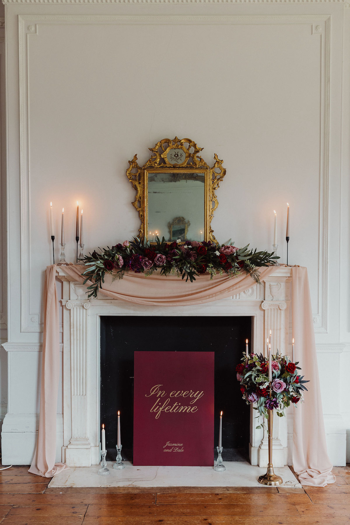 fireplace dressed with flowers, candles and drapes for an alternative wedding