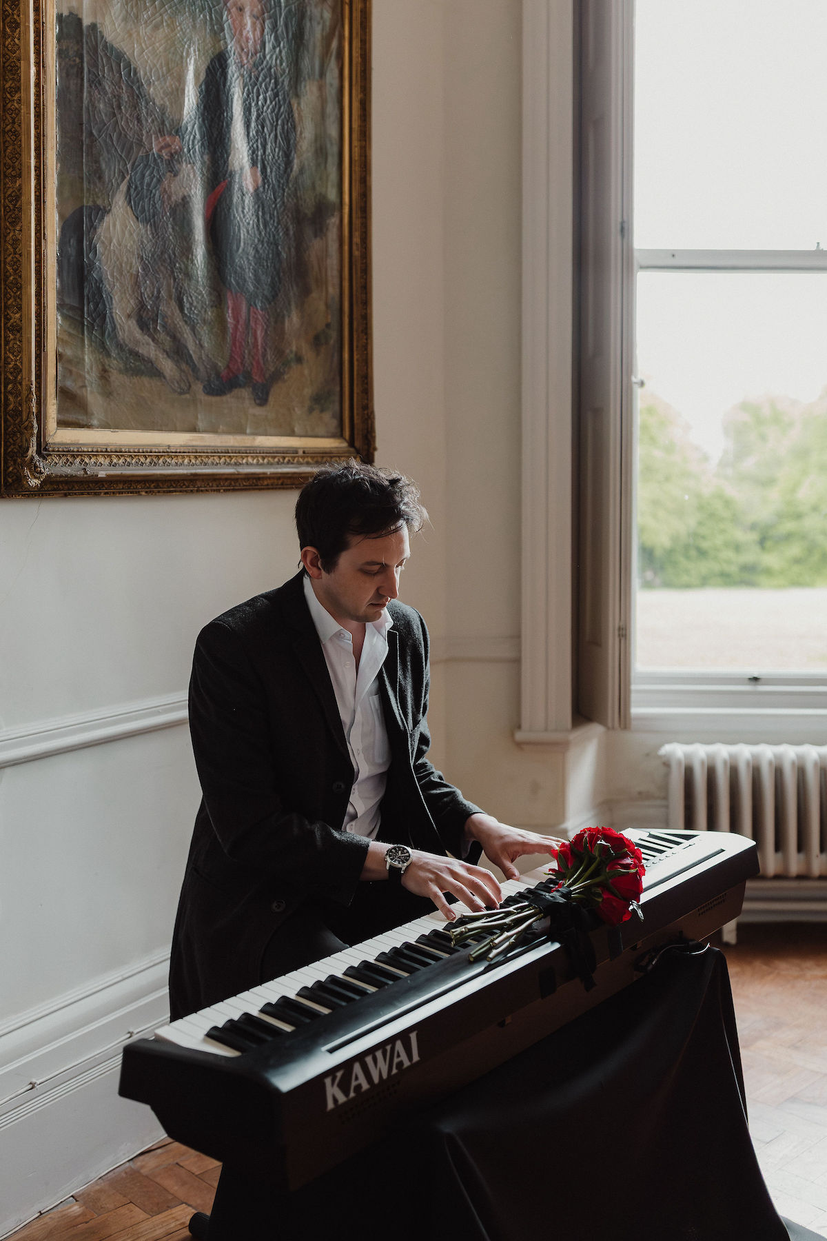 portrait of alternative wedding piano player sat at his keyboard