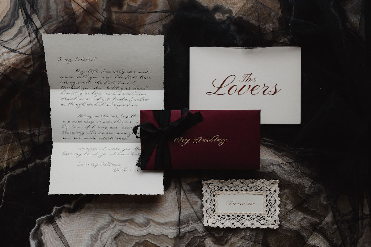 hand written love letter with envelope, place setting card and table sign for intimate wedding